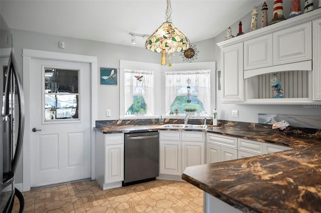 kitchen with pendant lighting, sink, white cabinetry, appliances with stainless steel finishes, and dark stone countertops