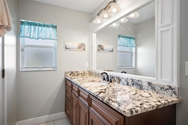 bathroom featuring a wealth of natural light, tile patterned floors, and vanity