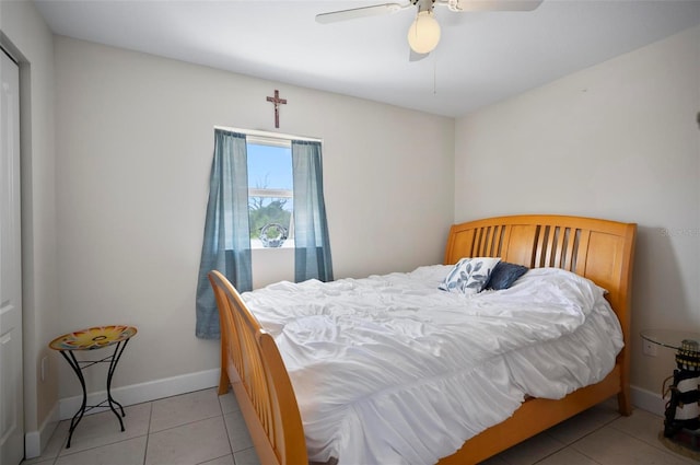 tiled bedroom featuring ceiling fan