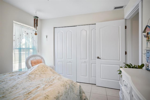 tiled bedroom with a closet