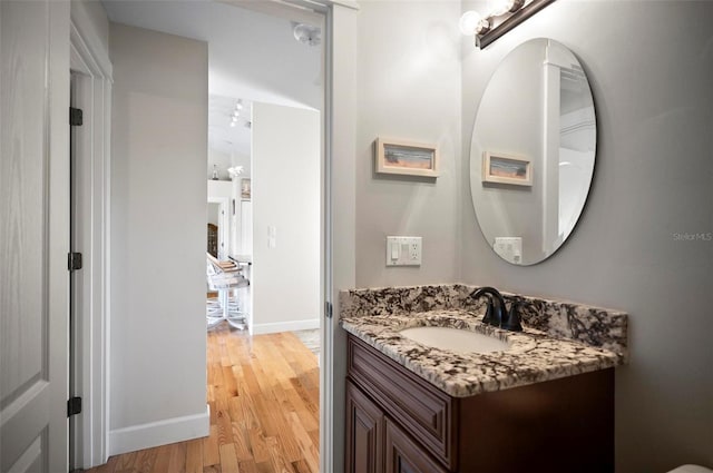 bathroom with vanity and hardwood / wood-style flooring