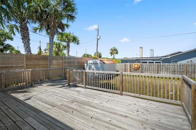 deck with a lawn and a storage unit