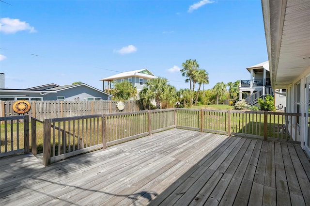 wooden deck featuring a yard