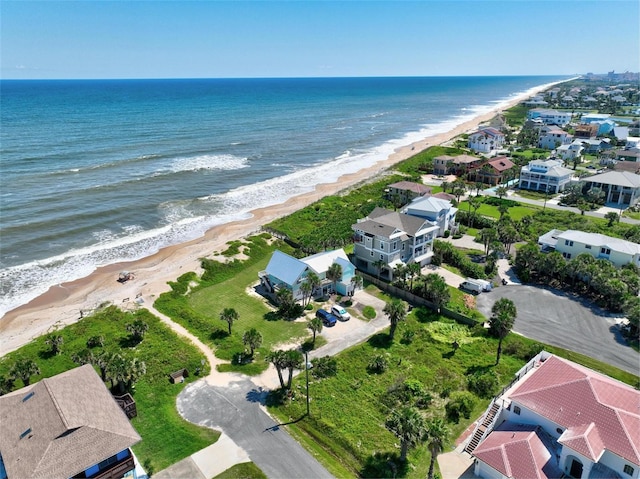 birds eye view of property featuring a view of the beach and a water view