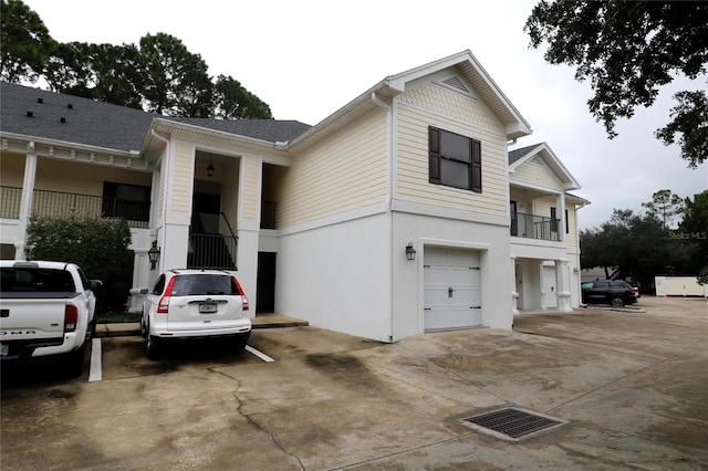 view of front of property with a balcony and a garage