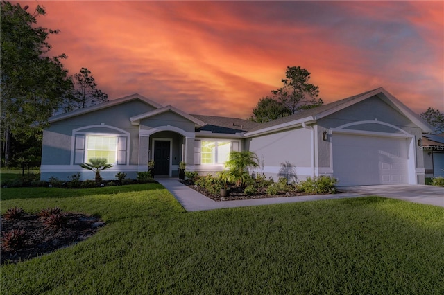 ranch-style home with a garage and a yard