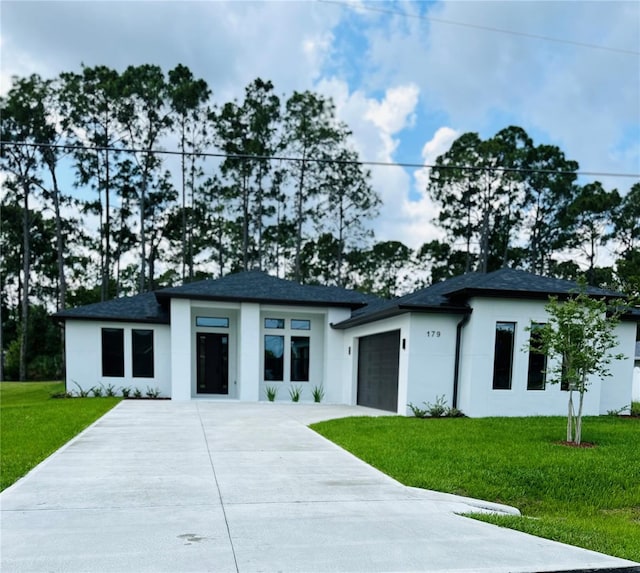 view of front of house with a garage and a front yard