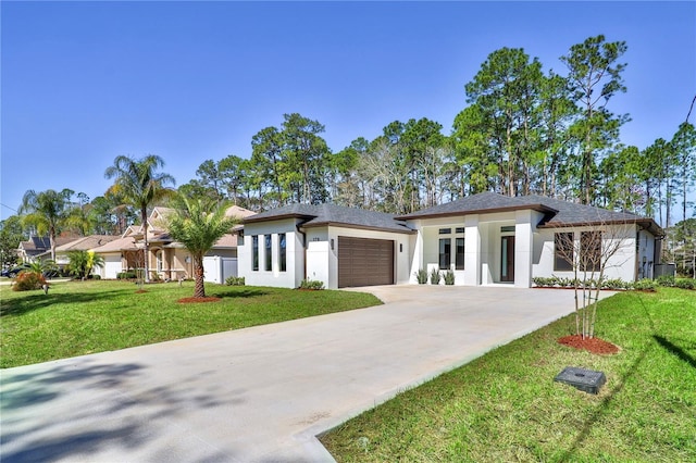 prairie-style home with concrete driveway, a front lawn, an attached garage, and stucco siding