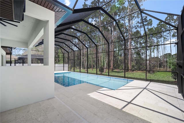 pool with glass enclosure and a patio