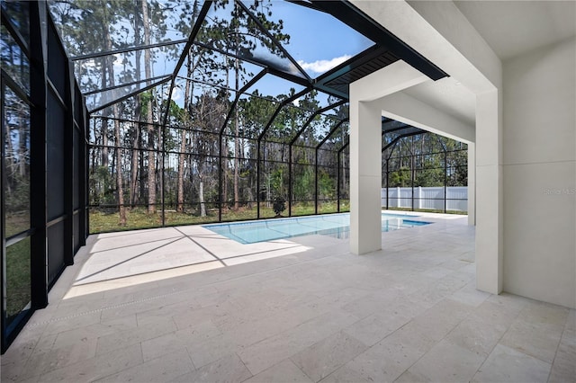 view of swimming pool featuring glass enclosure, a fenced in pool, and a patio