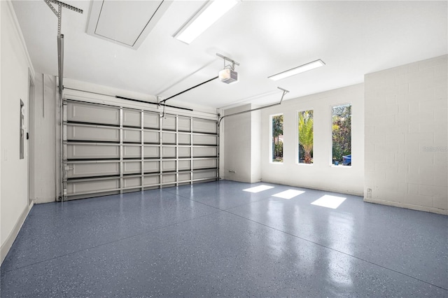 garage with concrete block wall and a garage door opener