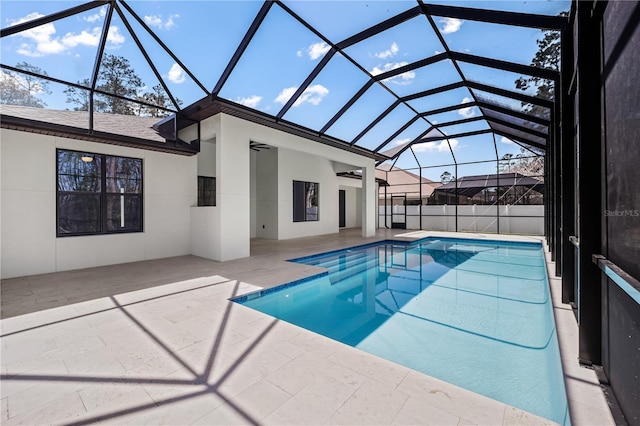 view of pool with a patio area, glass enclosure, and a fenced in pool