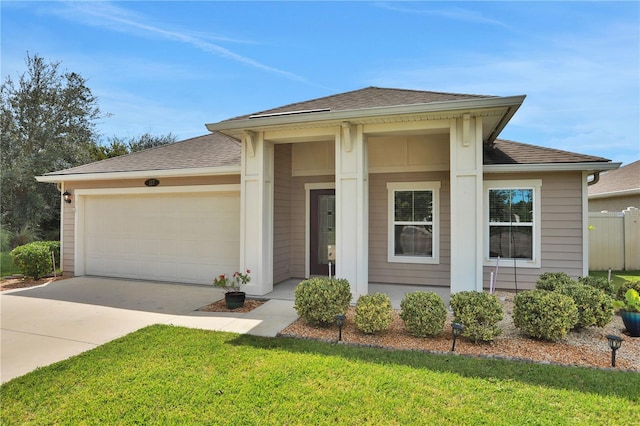 view of front facade with a front yard and a garage