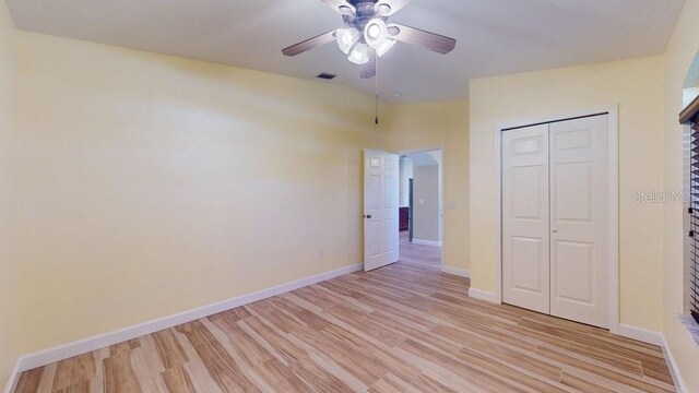 unfurnished bedroom featuring ceiling fan, a closet, and light hardwood / wood-style floors