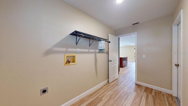 corridor with light wood-type flooring