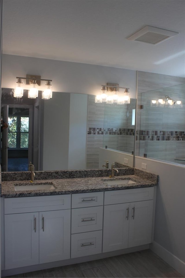 bathroom with wood-type flooring and vanity