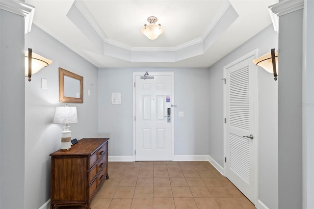 entryway with a raised ceiling, light tile patterned flooring, and crown molding