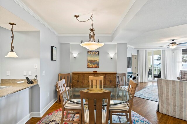 dining room featuring ceiling fan, dark hardwood / wood-style floors, and crown molding