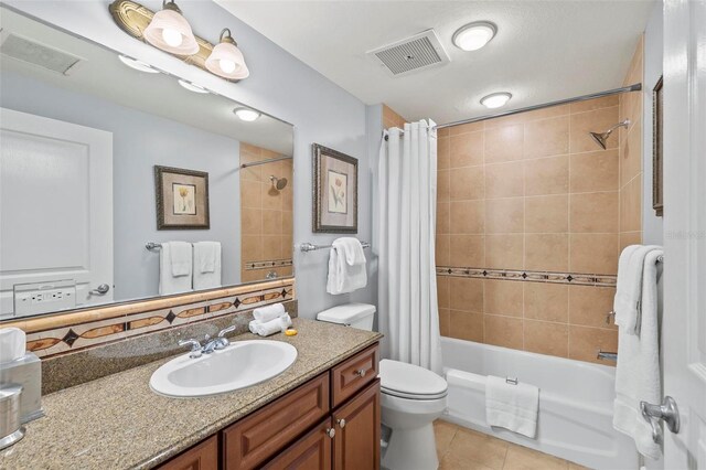 full bathroom featuring vanity, shower / tub combo, toilet, and tile patterned floors