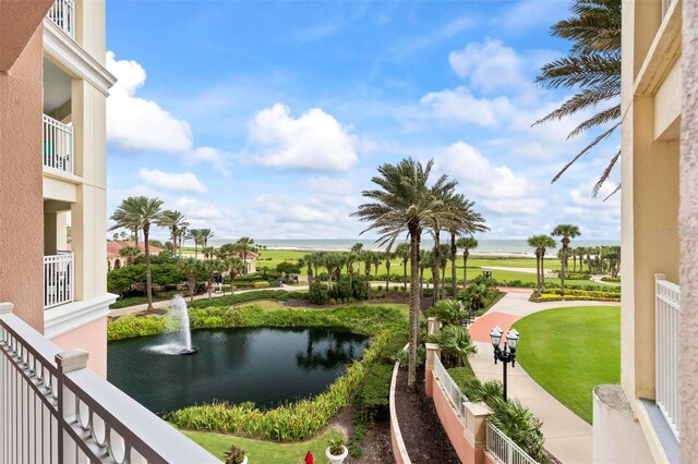 view of community featuring a lawn and a water view