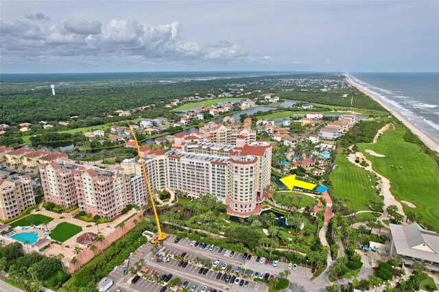 bird's eye view featuring a water view and a beach view