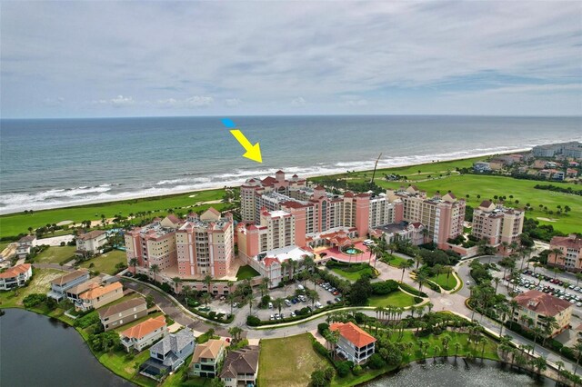 birds eye view of property featuring a water view and a beach view