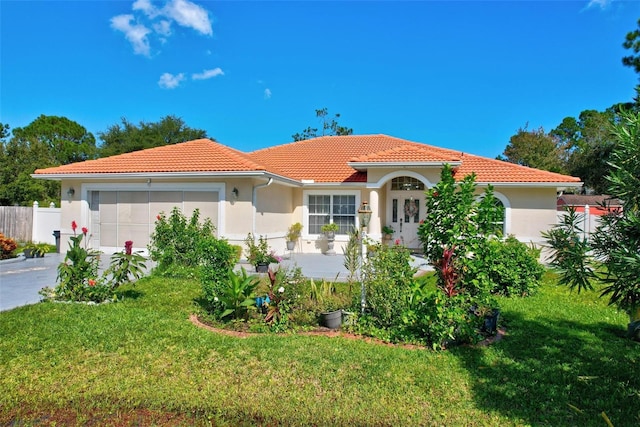 mediterranean / spanish-style home with a front lawn