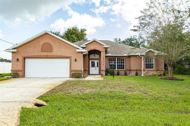 ranch-style house featuring a garage and a front lawn