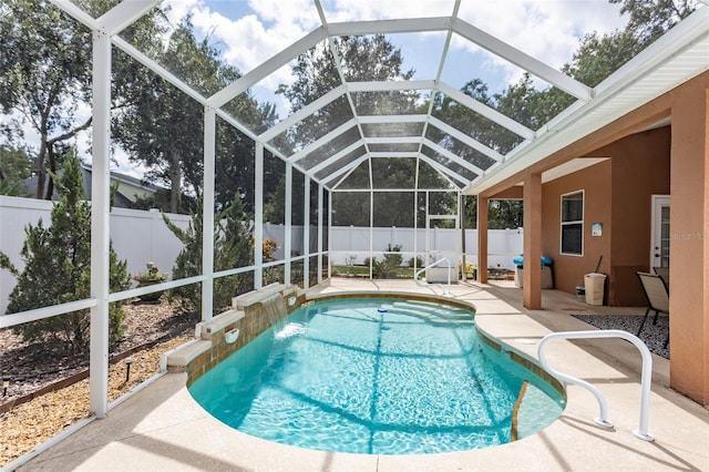 view of swimming pool featuring a patio, glass enclosure, and pool water feature