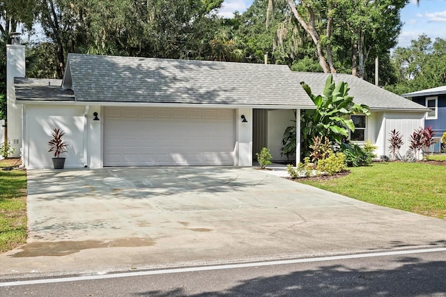 single story home with a front yard and a garage