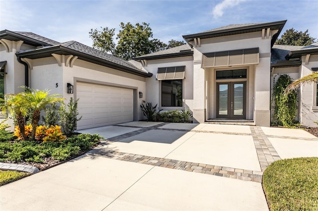 view of front of home with french doors and a garage