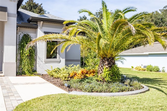 view of side of property with a lawn