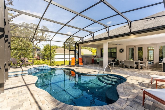 view of pool with french doors, a patio, glass enclosure, and ceiling fan