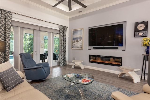 living room with crown molding, wood-type flooring, and ceiling fan