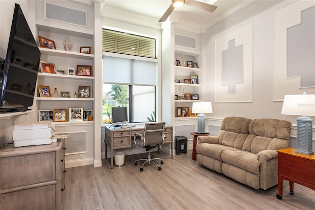 home office featuring crown molding, built in features, light hardwood / wood-style flooring, and ceiling fan