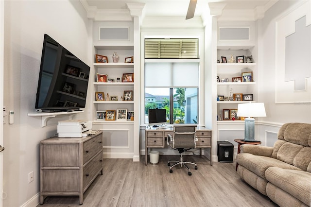 office with ceiling fan, built in features, ornamental molding, and light wood-type flooring