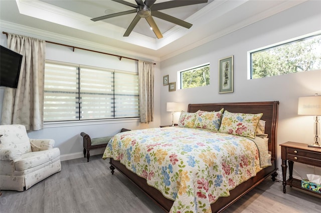 bedroom with ornamental molding, hardwood / wood-style floors, and ceiling fan