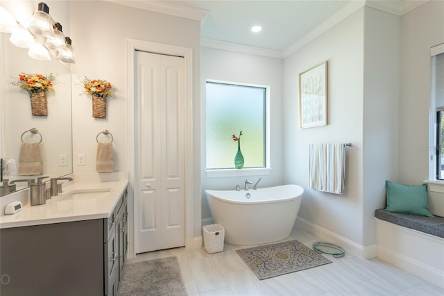 bathroom with vanity, ornamental molding, and a bath