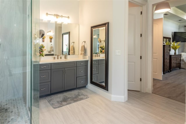 bathroom with a shower with door, vanity, ornamental molding, and wood-type flooring