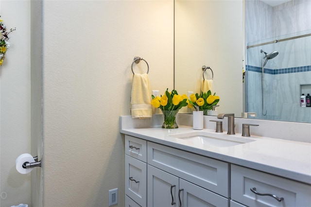 bathroom with vanity and tiled shower