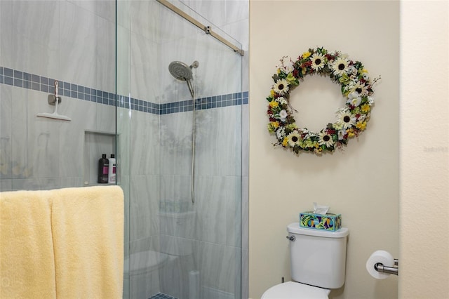 bathroom featuring toilet and walk in shower