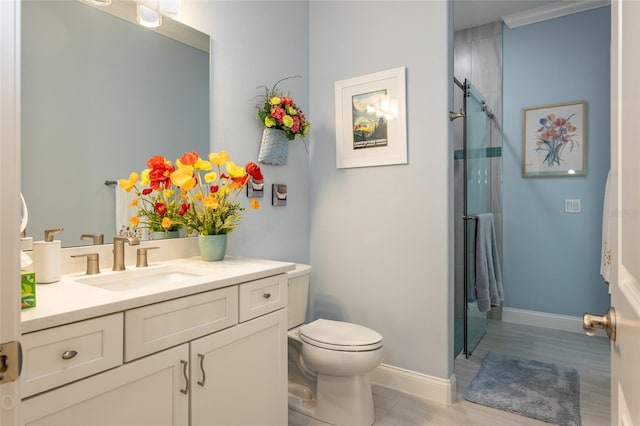 bathroom featuring toilet, wood-type flooring, ornamental molding, curtained shower, and vanity