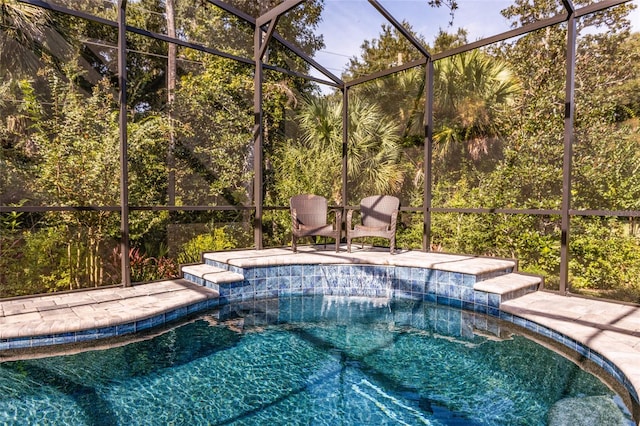 view of pool with glass enclosure