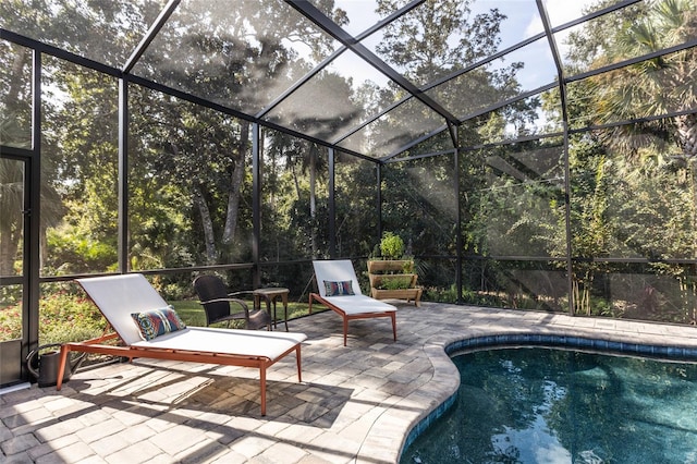 view of pool with a patio and a lanai