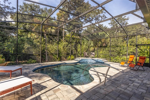 view of swimming pool with a hot tub, a patio, and glass enclosure