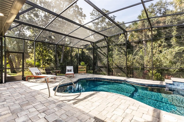 view of pool with a patio and glass enclosure