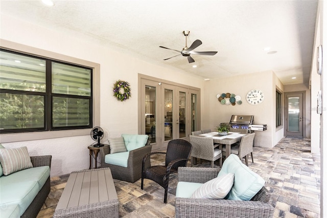 view of patio / terrace with french doors, area for grilling, an outdoor living space, and ceiling fan