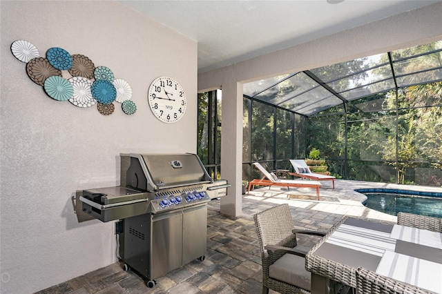 view of patio / terrace with area for grilling and glass enclosure