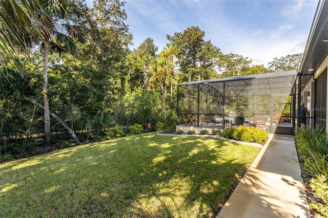 view of yard with a patio and glass enclosure