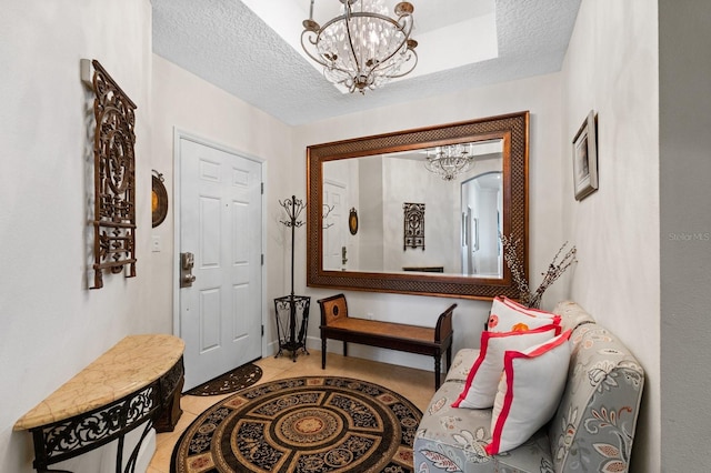 entrance foyer with a textured ceiling and a chandelier